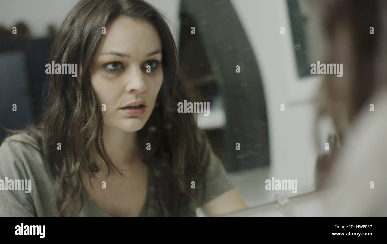 Selektiven Fokus Blick auf traurige misshandelte Frau Prüfung verletzte Gesicht im Spiegel Stockfoto