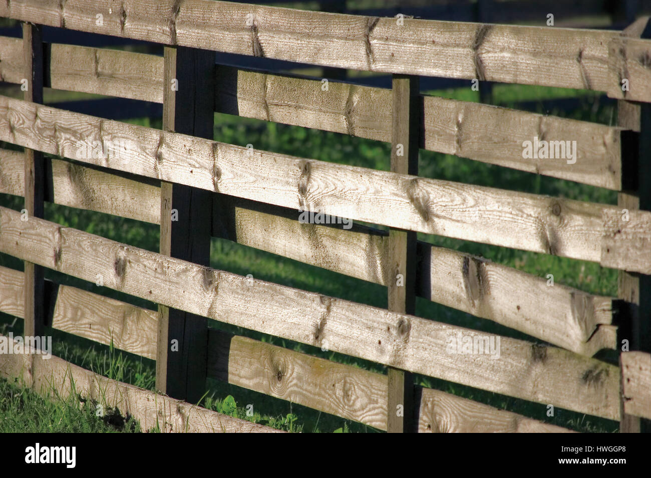 Großen horizontalen verwitterten hölzernen Zaun Panel In Grass Stockfoto