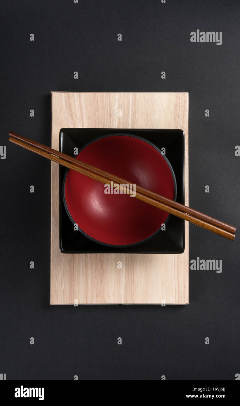 Chinesische Gerichte und Ess-Stäbchen auf Bambus-Brett angeordnet Stockfoto