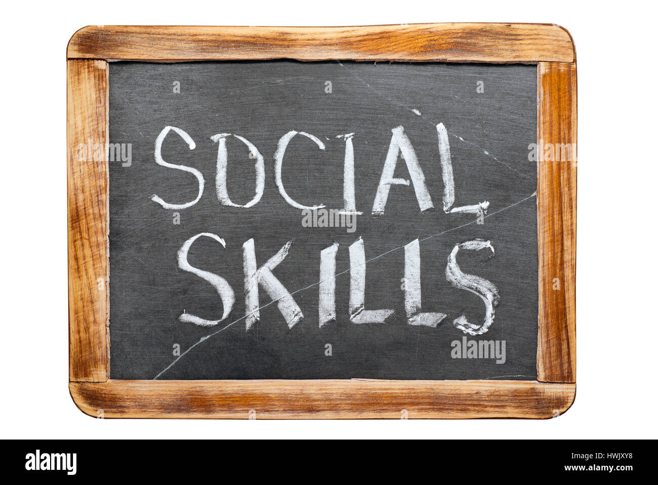 soziale Kompetenz Ausdruck handschriftlich auf Vintage Schiefer Schulbehörde isoliert auf weiss Stockfoto