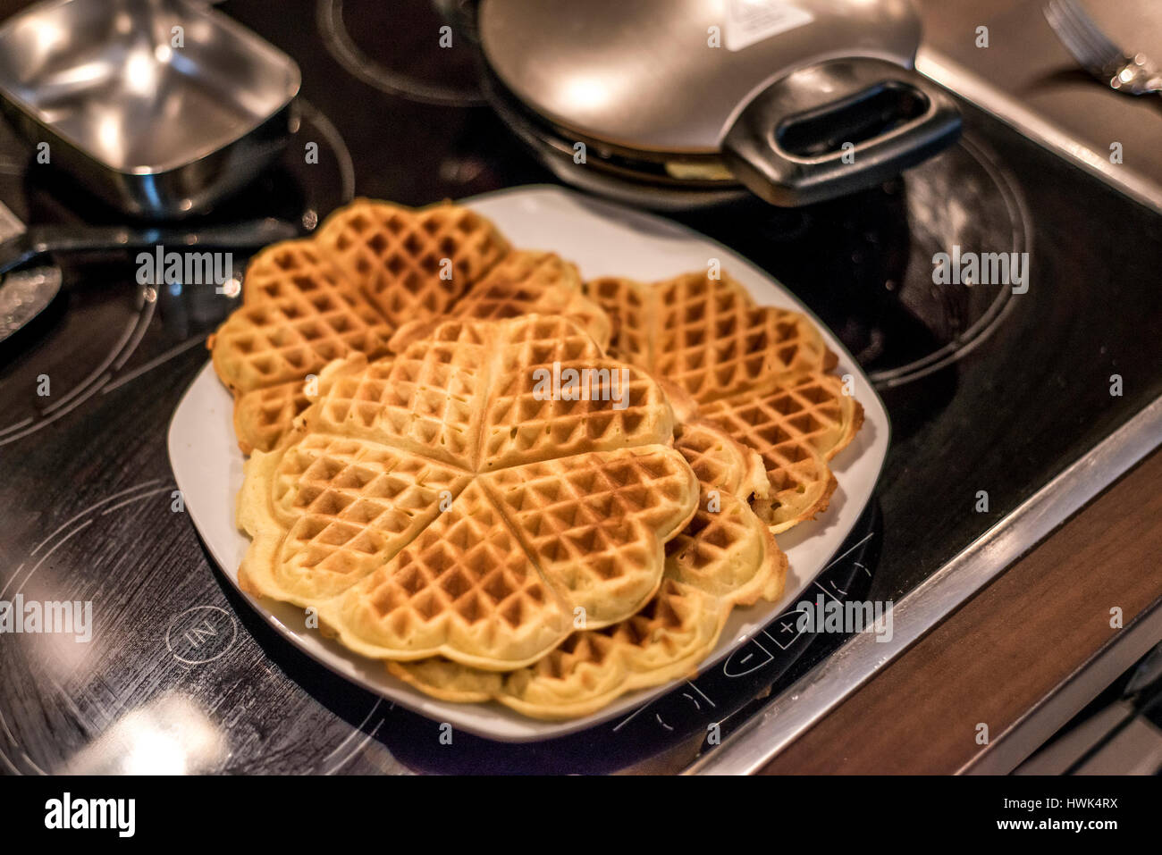 Hausgemachte Waffeln werden in einem Waffeleisen zubereitet. Stockfoto