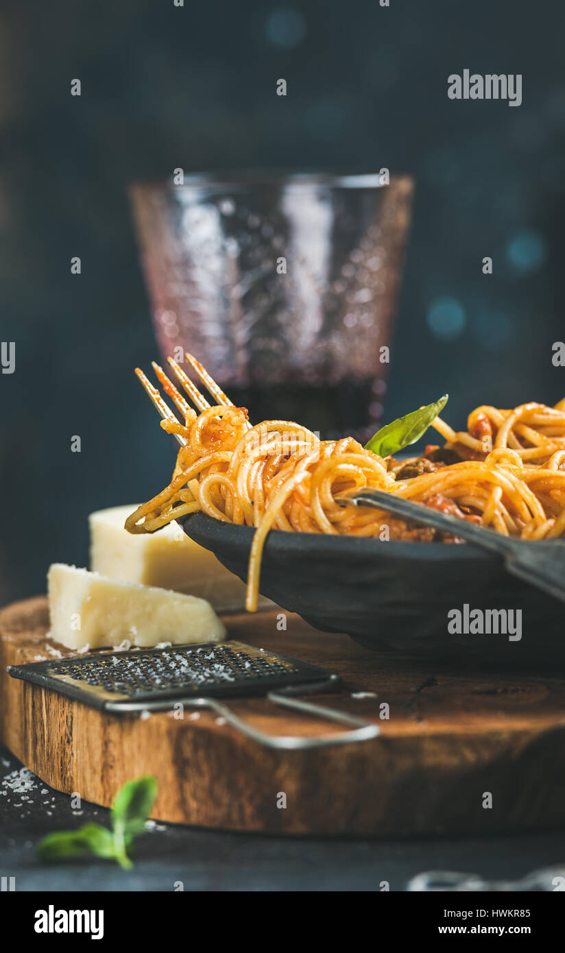 Spaghetti mit Meatballas, Basilikum, Parmesan-Käse und Wein im Glas Stockfoto