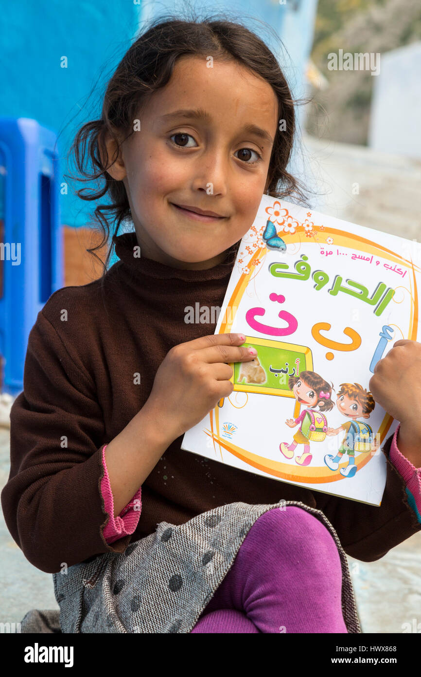 Chefchaouen, Marokko.  Kleines Mädchen zeigt ihre Schule Buch verwendet, um das arabische Alphabet zu lernen. Stockfoto