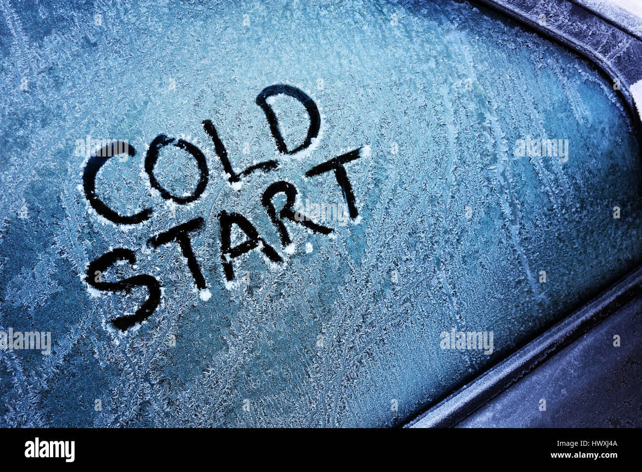 Kalt-Start-Nachricht geschrieben am zugefrorenen Autofenster Windschutzscheibe Stockfoto