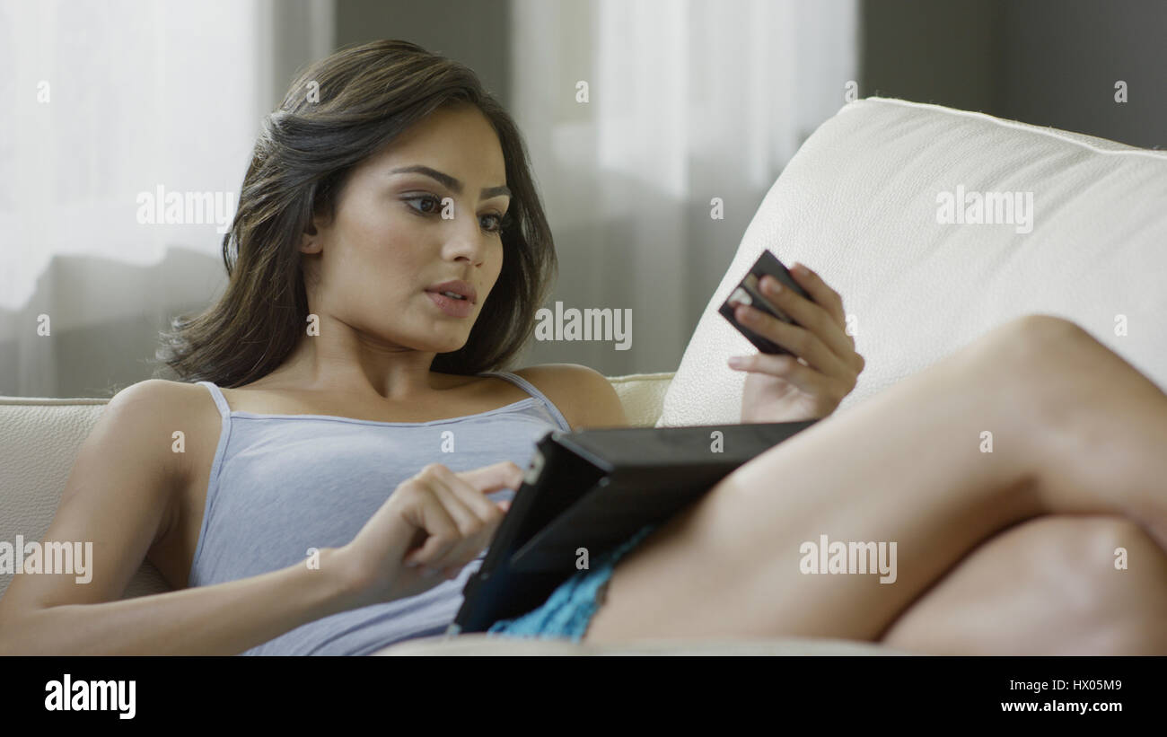 Selektiven Fokus Blick auf Frau online-shopping mit Kreditkarte und digital-Tablette auf sofa Stockfoto