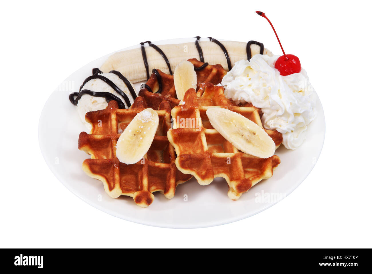 Dessert mit belgischen Waffeln, Eis, Schlagsahne und ein Stück Banane ist auf dem Teller, isoliert auf weißem Hintergrund, keine Körper. Stockfoto