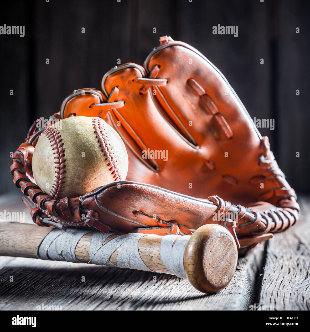 Goldener Handschuh und alte Baseball Ball auf alten Holztisch Stockfoto