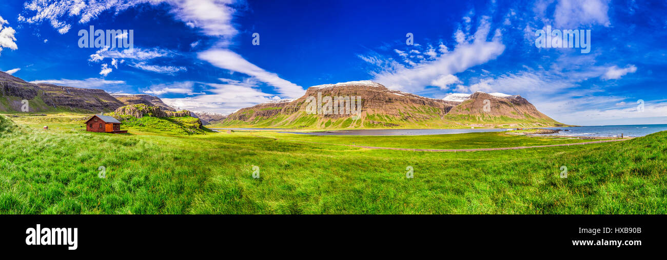Panorama der Berge mit kleinen Häuschen, Island Stockfoto