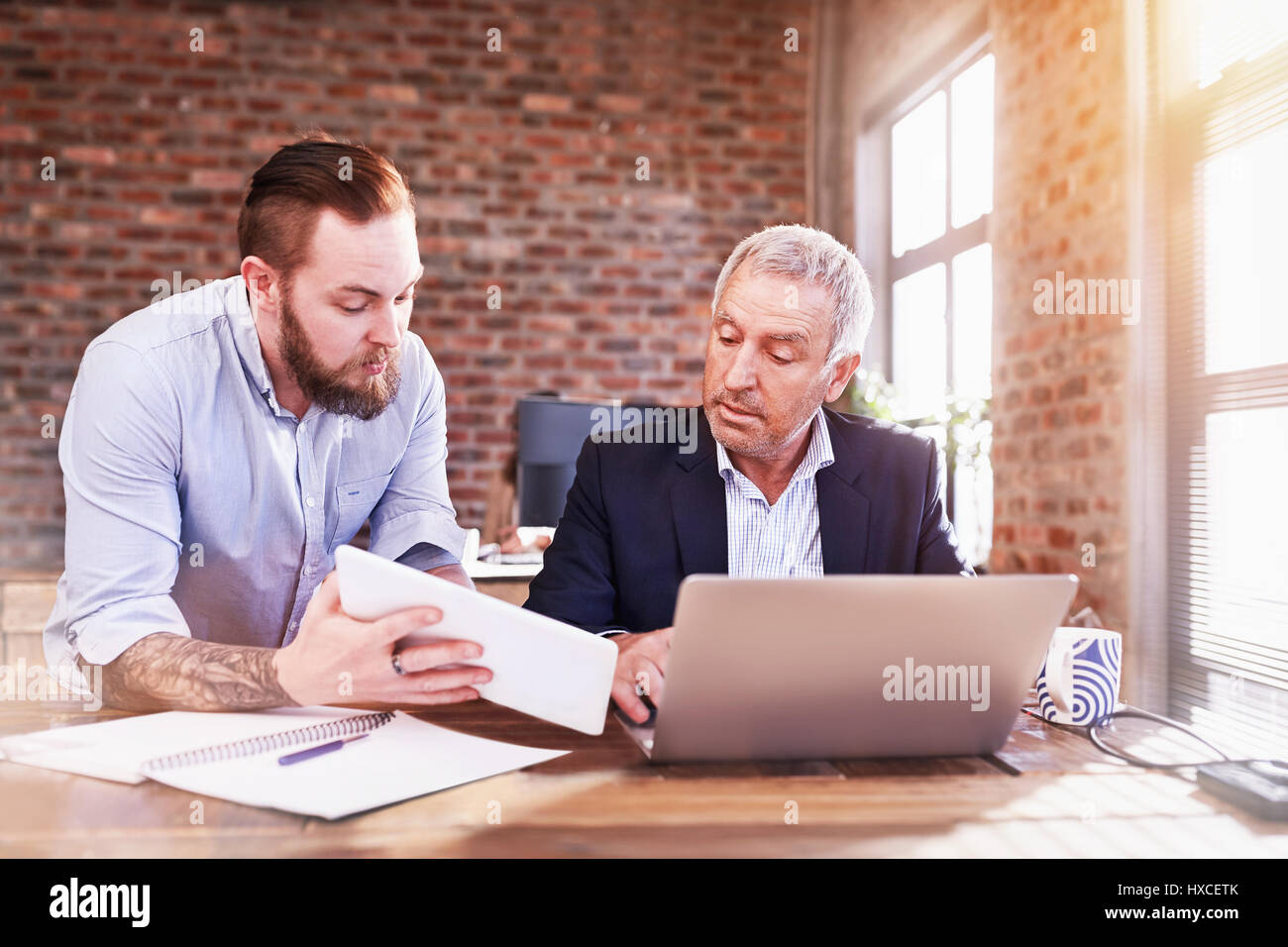 Unternehmer mit digitalen Tablet-PC und Laptop arbeiten im Büro Stockfoto