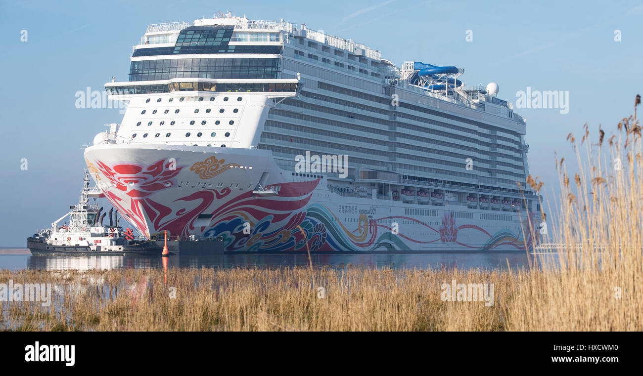 Oldersum, Deutschland. 27. März 2017. Das neueste Kreuzfahrtschiff der Meyer Shipyard in Papenburg, 'Norwegische Freude', kommt an der Nordsee während seiner Übertragung Tordurchgang Fluss Ems in Oldersum, Deutschland, 27. März 2017. Der Riese für den chinesischen Markt gebaut, wird es die nächste Flut warten. Das 324 Meter lang und 167.800 BRZ großen Passagier Schiff der US-Reederei, die Norwegian Kreuzfahrten im niederländischen Eemshaven andocken und dann wird es für die Nordsee verlassen. Foto: Ingo Wagner/Dpa/Alamy Live News Stockfoto