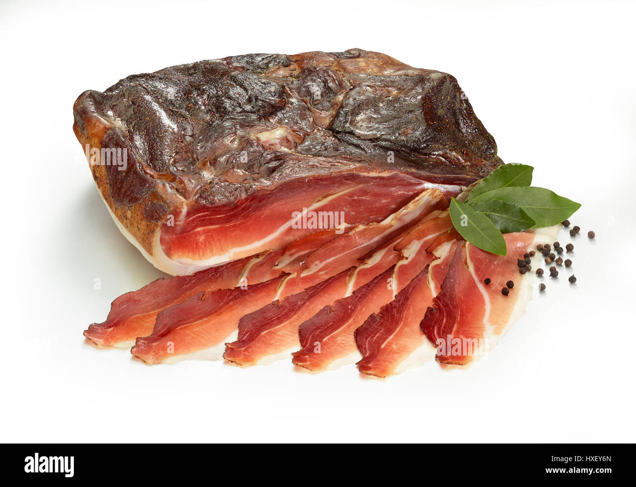 Südtiroler Schinken mit Lorbeer (Laurus Nobilis) und Pfefferkörner (Piper) als Dekoration Stockfoto