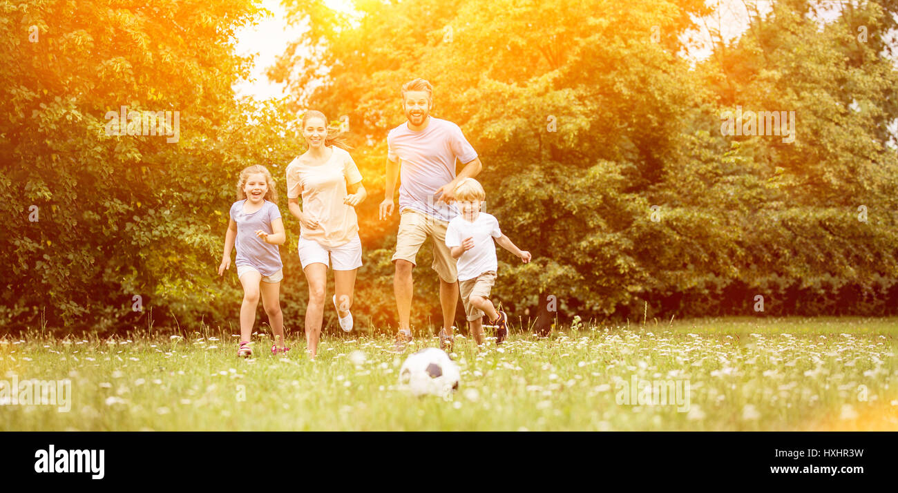 Familie mit Fußball im Sommer spielen und Spaß Stockfoto