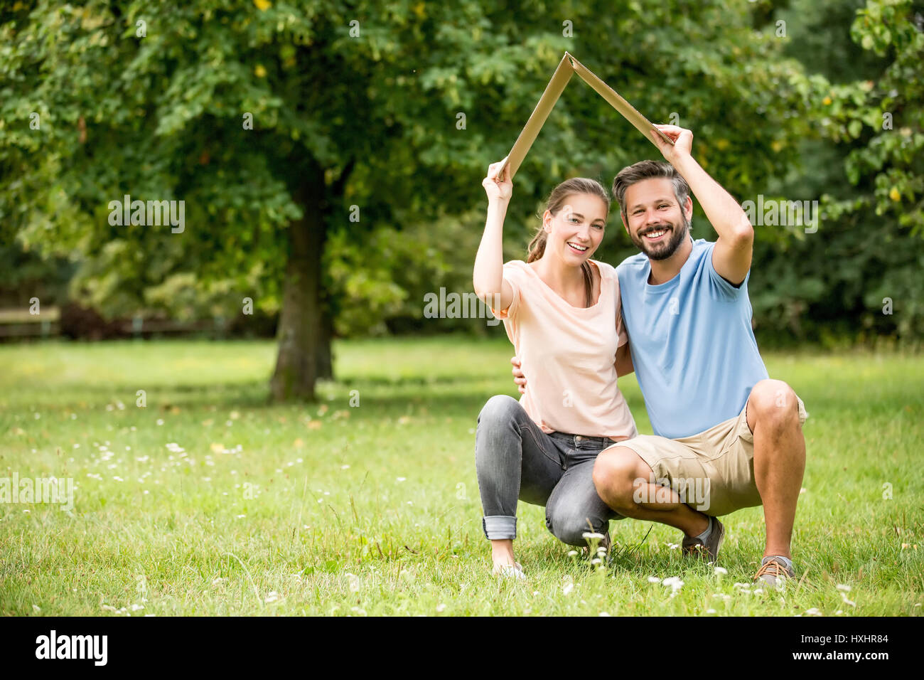 Paar Holding-Dach als Bau- oder Sicherheit Wohnkonzept Stockfoto