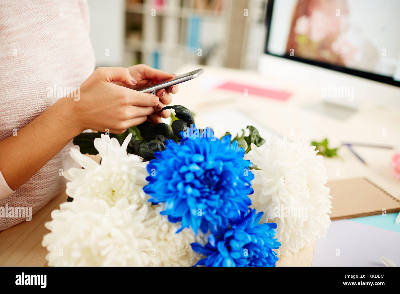 Weibliche Blumengeschäft mit smartphone Stockfoto