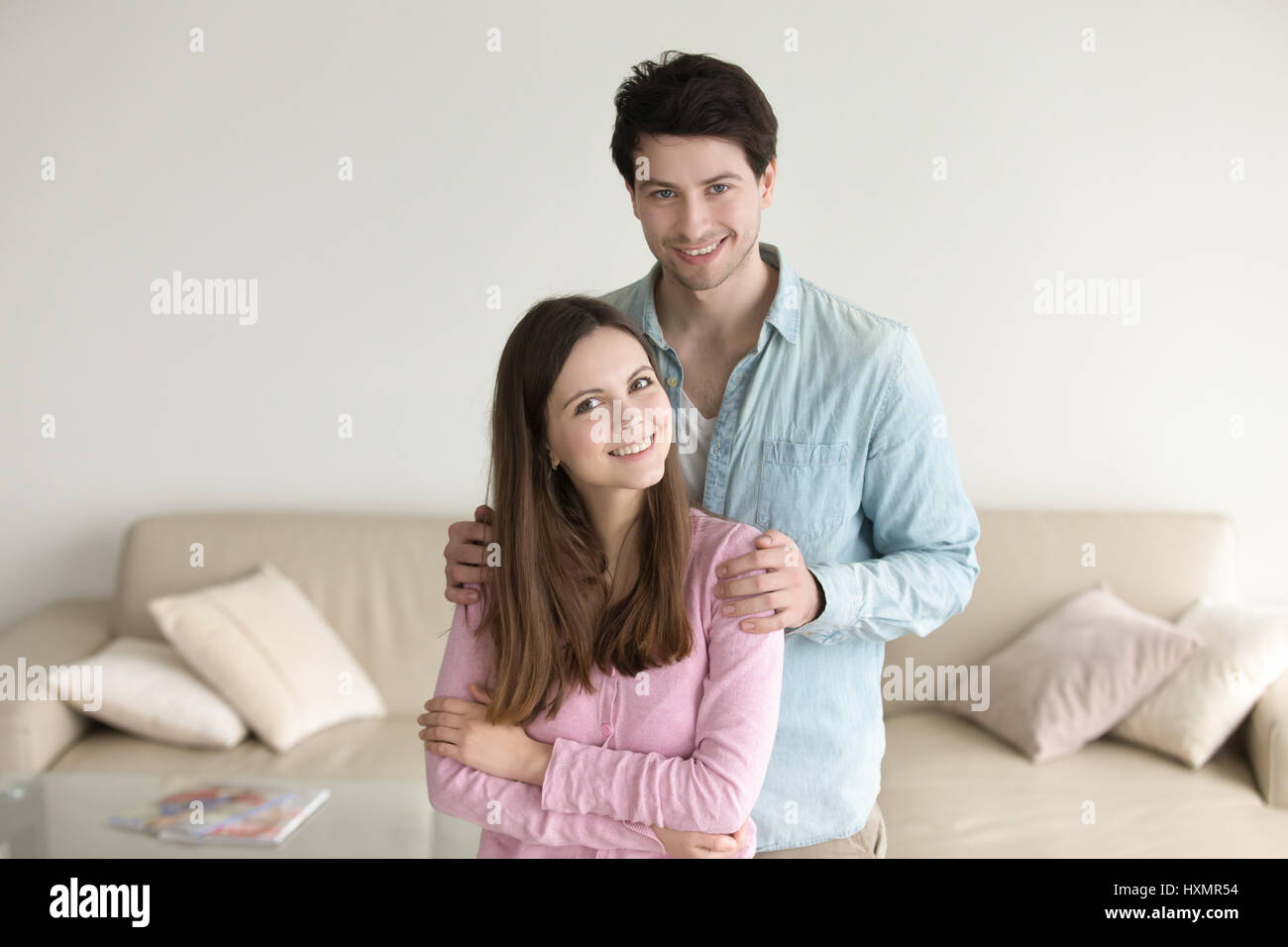 Porträt des jungen Paares lächelnd umarmen zu Hause glücklich relati Stockfoto