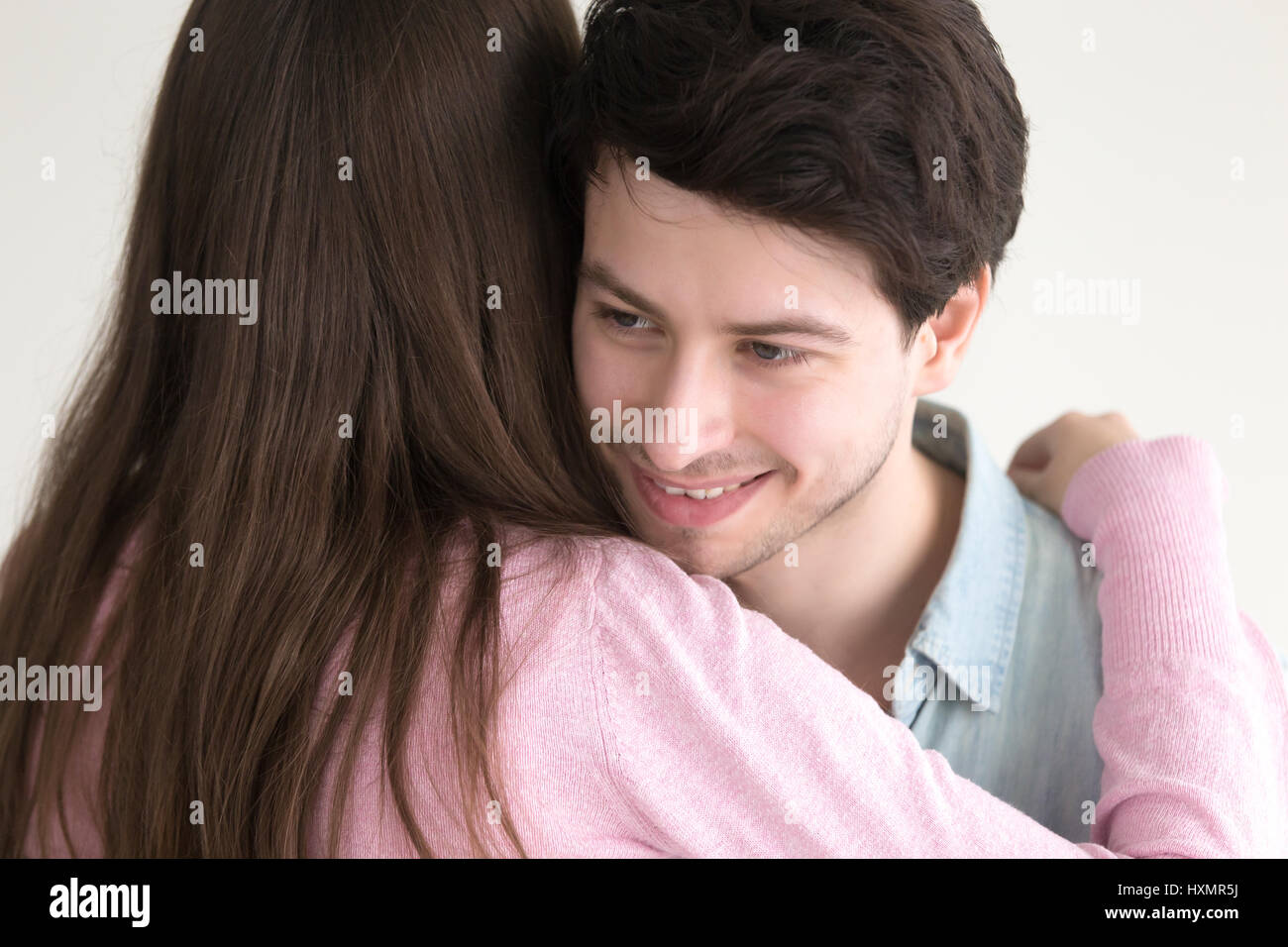 Hübschen Kerl umarmt junge Dame, paar umarmt auf Dat Lächeln Stockfoto