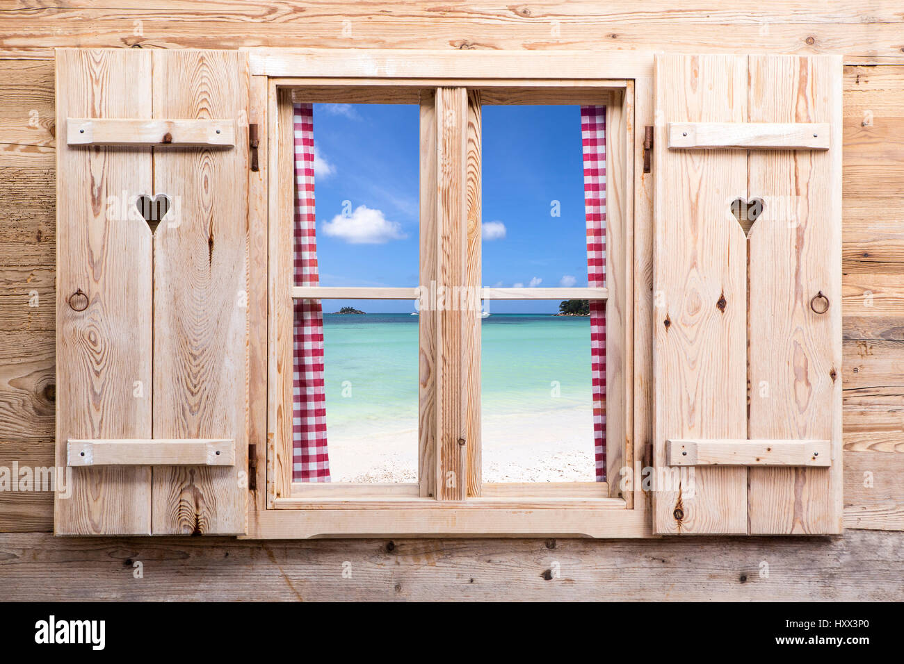 Holzfenster mit Panoramablick auf Strand, Reisekonzept Stockfoto