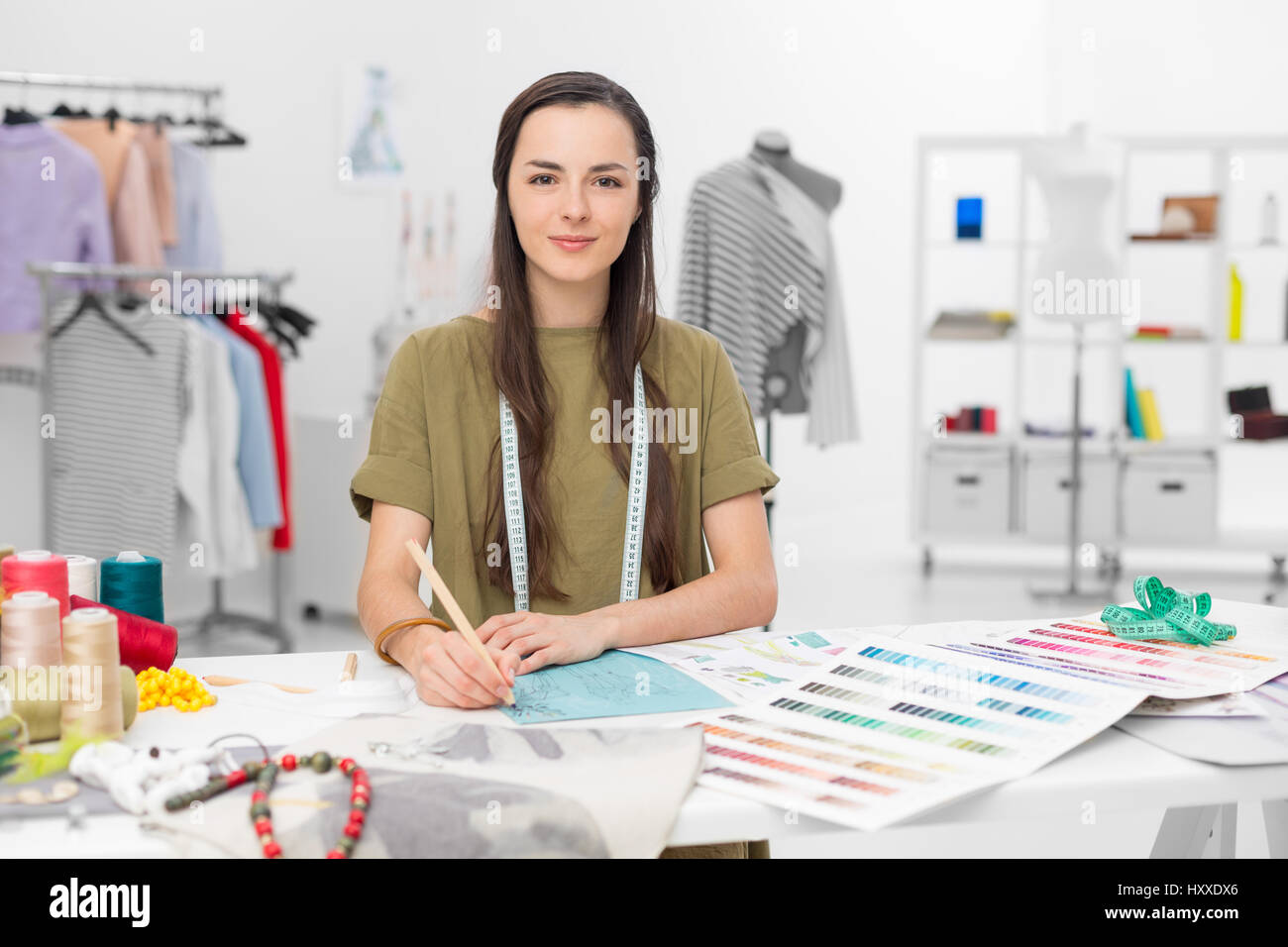junge Mode-Designer am Schreibtisch in ihrem Atelier Stockfoto