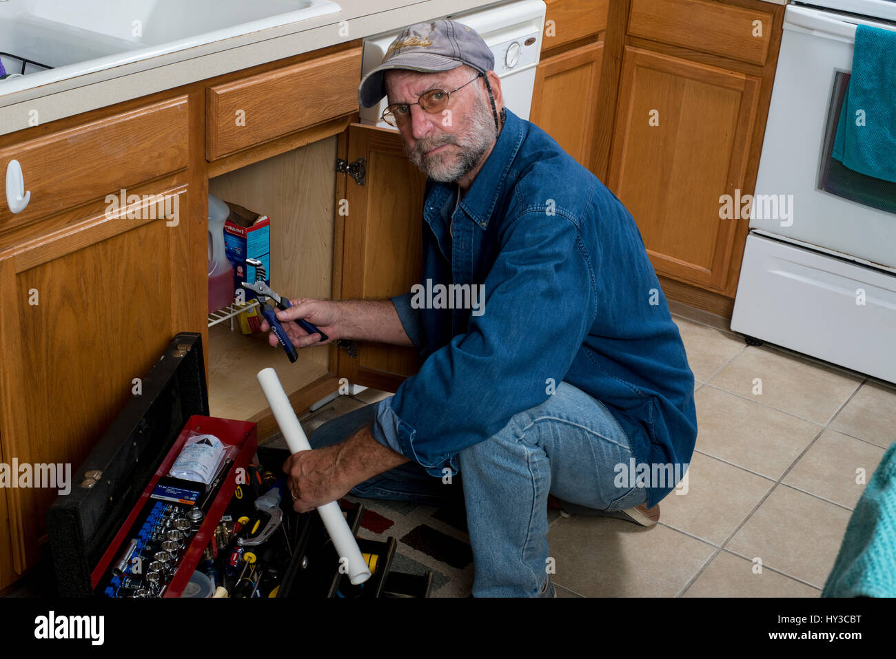 handliche Mann mit Werkzeugen in Küche Stockfoto