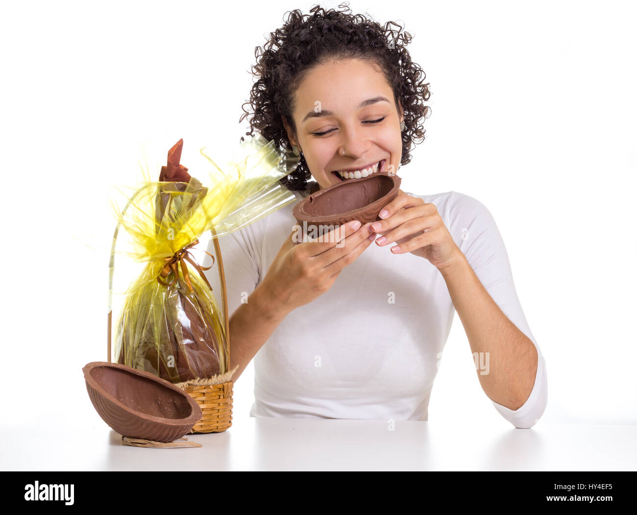 Glückliches Mädchen genießt die Osterzeit mit Schokoladen-Ei zu frönen. Stockfoto