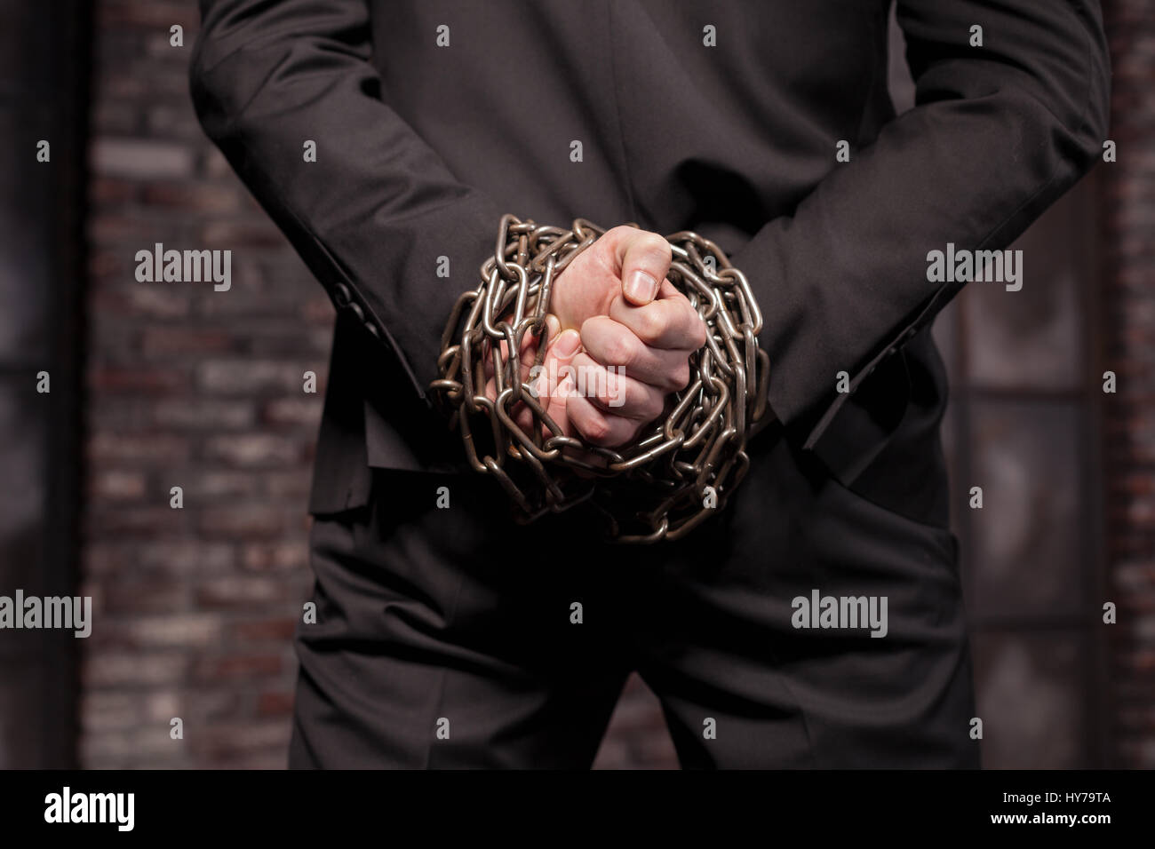 Stille Mörder Hände in Eisenkette zurück, Ansicht, Tapete, Poster oder Hintergrund Konzept. Auftragskiller. Professionelle Geheimagenten. Schalldämpfer-Mann Stockfoto