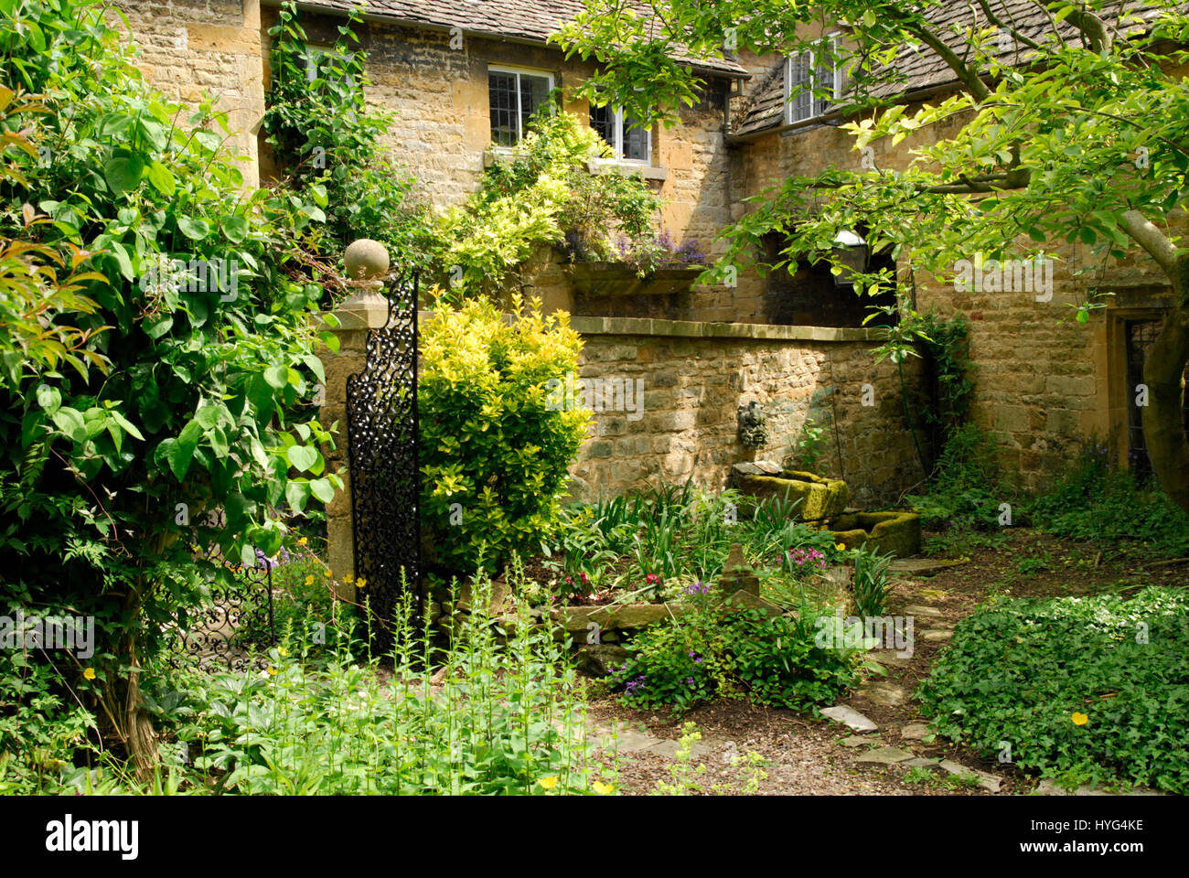 Szene in einem englischen Landhaus-Garten mit Cotswold Steinmauern und gemischte Pflanzung Stockfoto