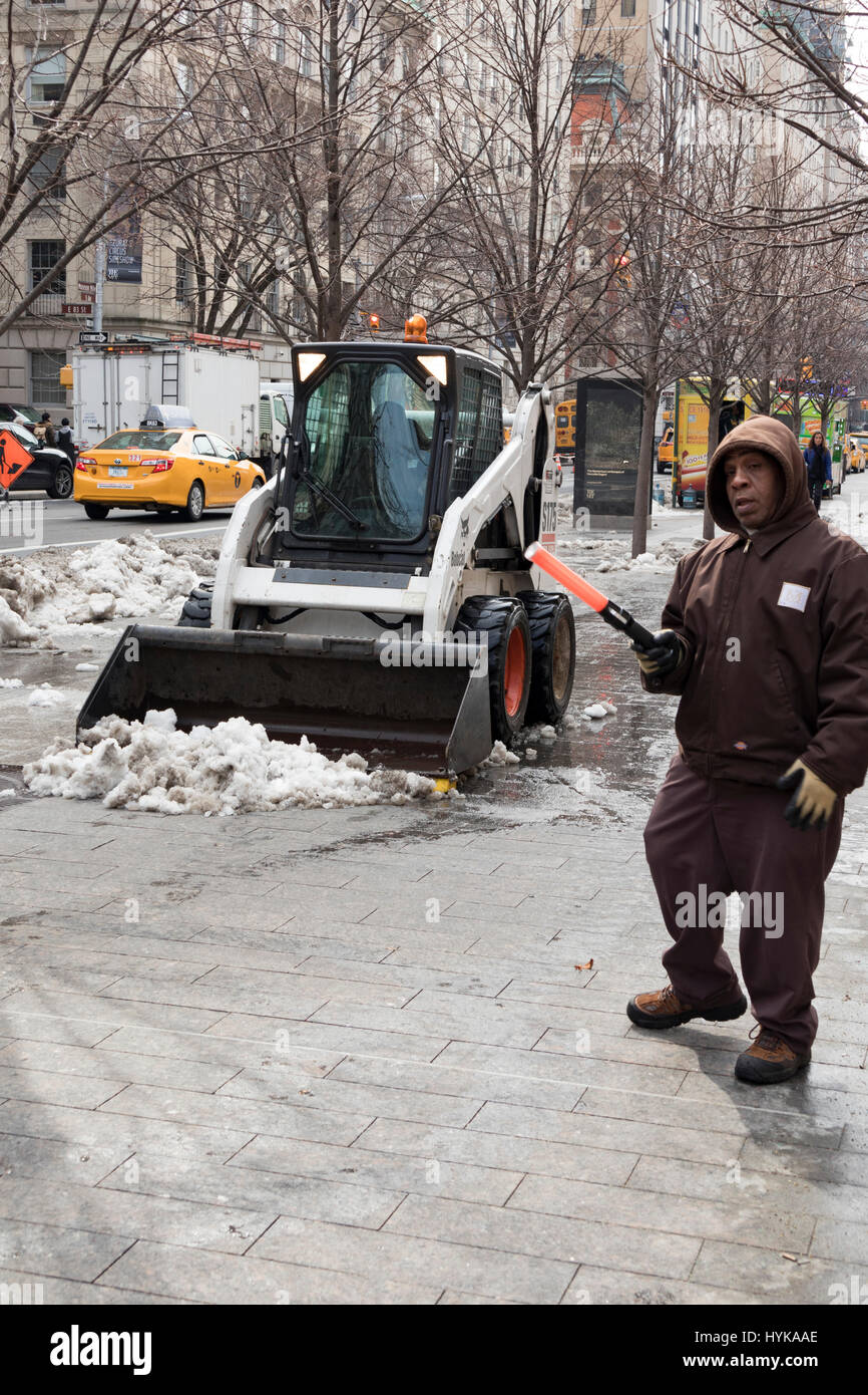 Schneepflug Clearing Bürgersteig am eisigen Tag im Winter, New York City, außerhalb Metropolitan Museum of Art, USA Stockfoto