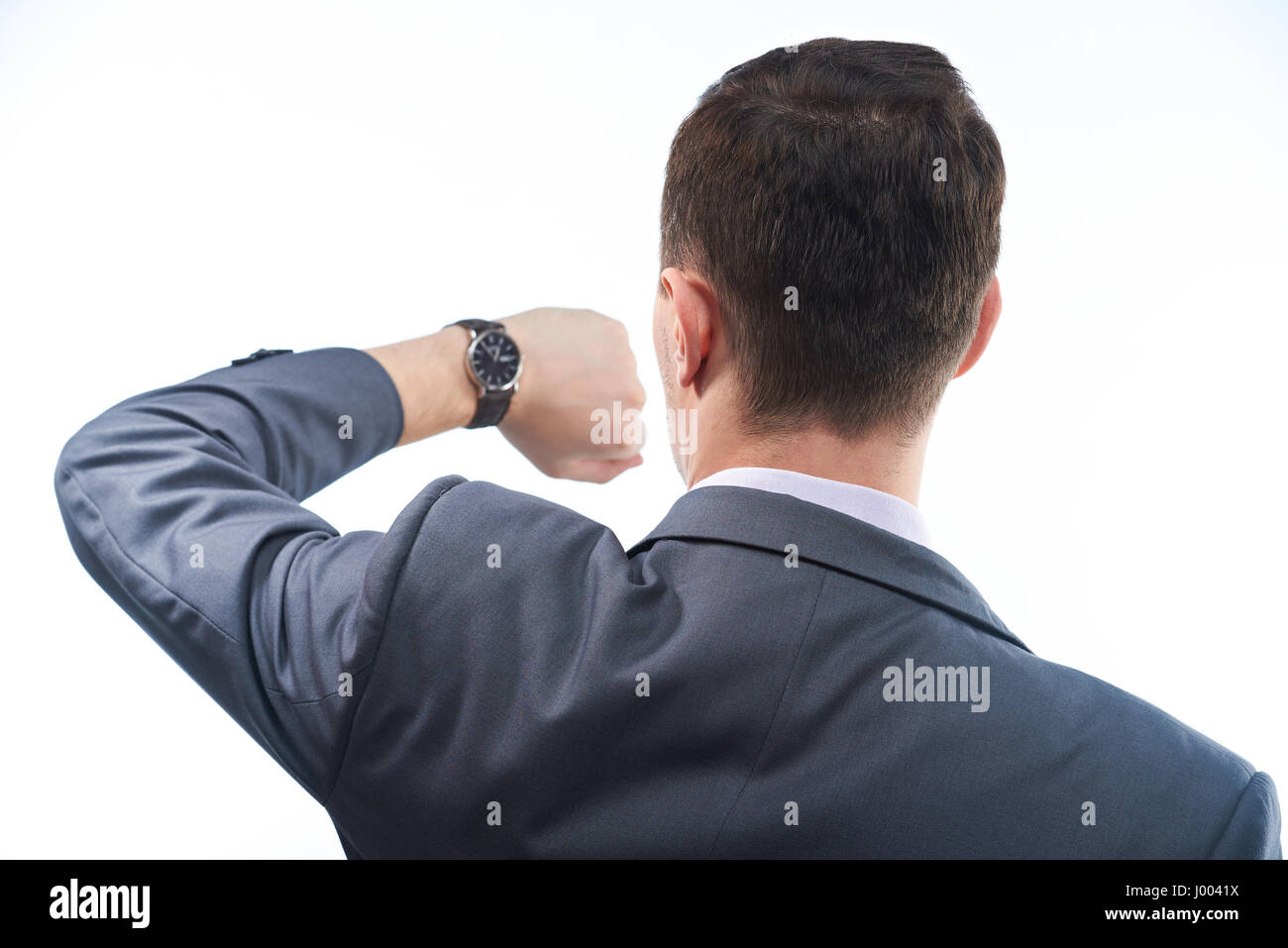 Geschäftsmann mit Uhr-Ansicht von hinten. Mann im Anzug überprüfen Sie, wie spät es ist. Stockfoto