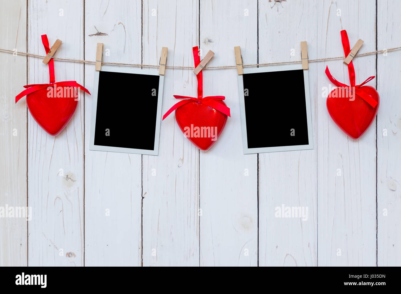 Foto Rahmen leer und roten Herzen hängen weiße Holz Hintergrund mit Raum Stockfoto
