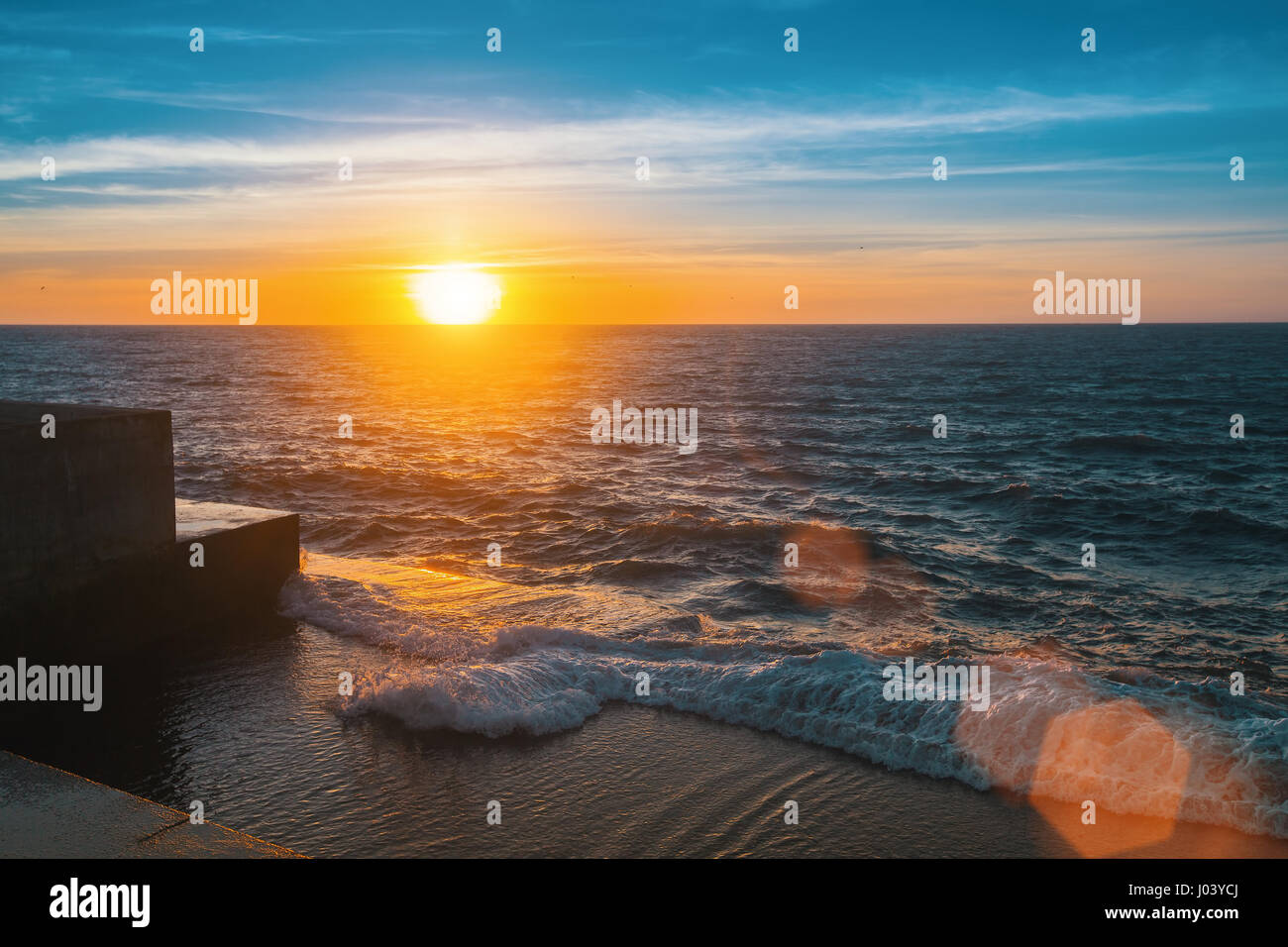 Sonnenuntergang am Meer Pier, Flare und Strahlen. Stockfoto