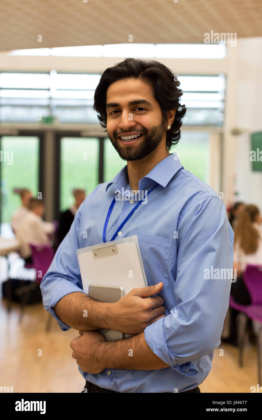 Taille Porträt einer Lehrerin. Er hält einige Papiere und eine digital-Tablette. Stockfoto