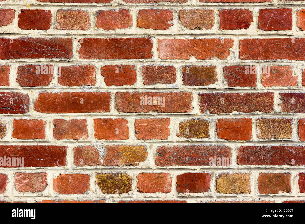 Schichtige rote Ziegelwandverkleidungs-Hintergrund Stockfoto
