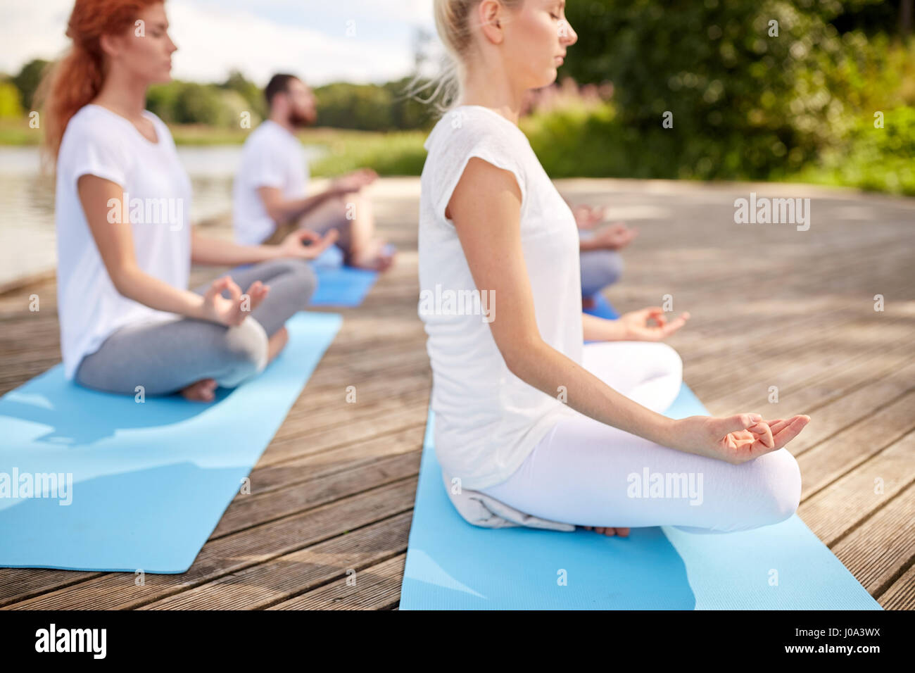 Nahaufnahme von Menschen, die Yoga-Übungen im freien Stockfoto