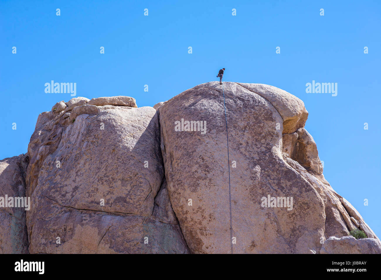 Eine Person auf einer Felsformation am Joshua Tree Natiional Park, Kalifornien, USA. Stockfoto