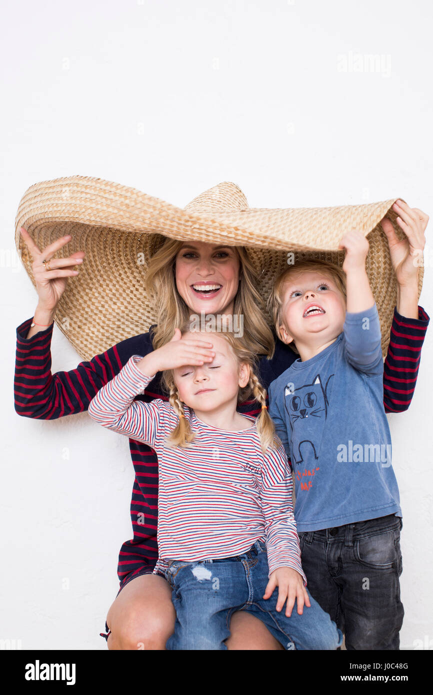 Frau trägt Sombrero, Abschirmung sich und zwei Kinder Stockfoto