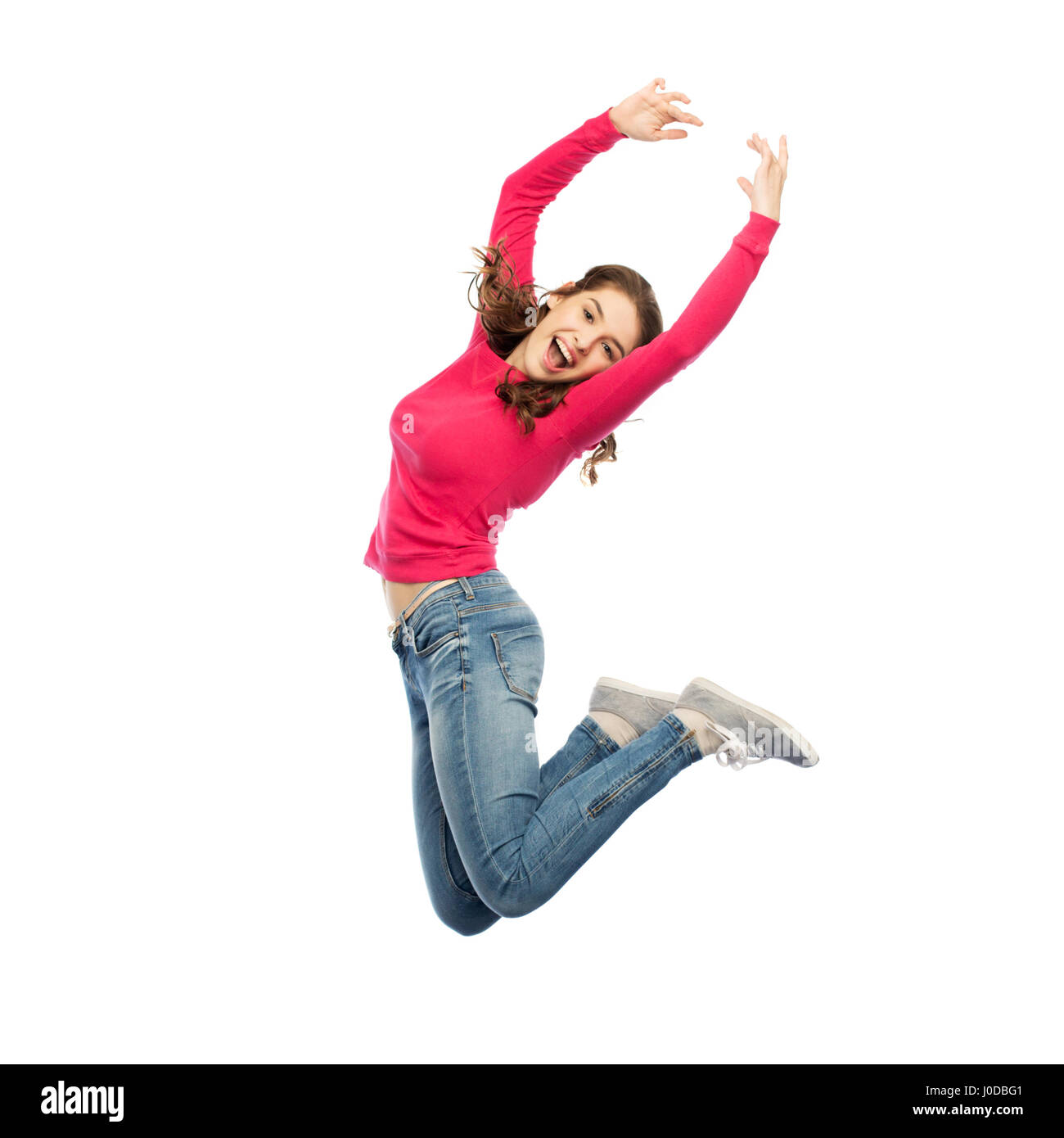 glückliche junge Frau in die Luft springen oder tanzen Stockfoto