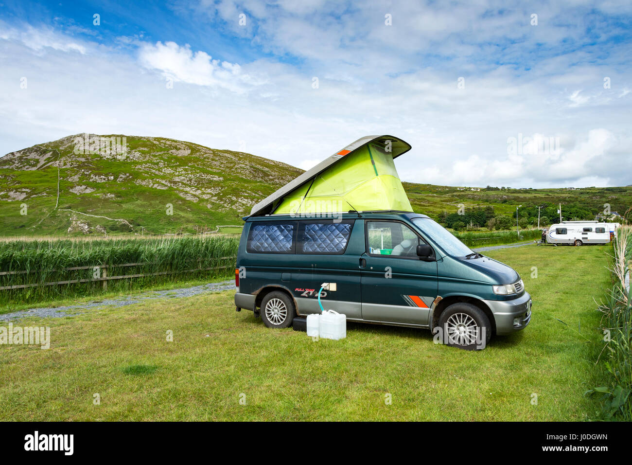 Ein Mazda Bongo Campervan auf Campingplatz Binion Bay, Tullagh Bay, Halbinsel Inishowen, County Donegal, Irland.  Binnion Hügel hinter. Stockfoto