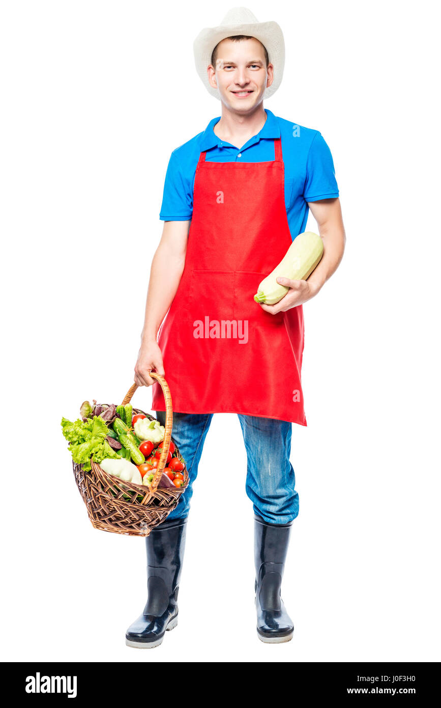 Vertikale Porträt eines Bauern in voller Länge mit einer Ernte von Gemüse auf weißem Hintergrund Stockfoto