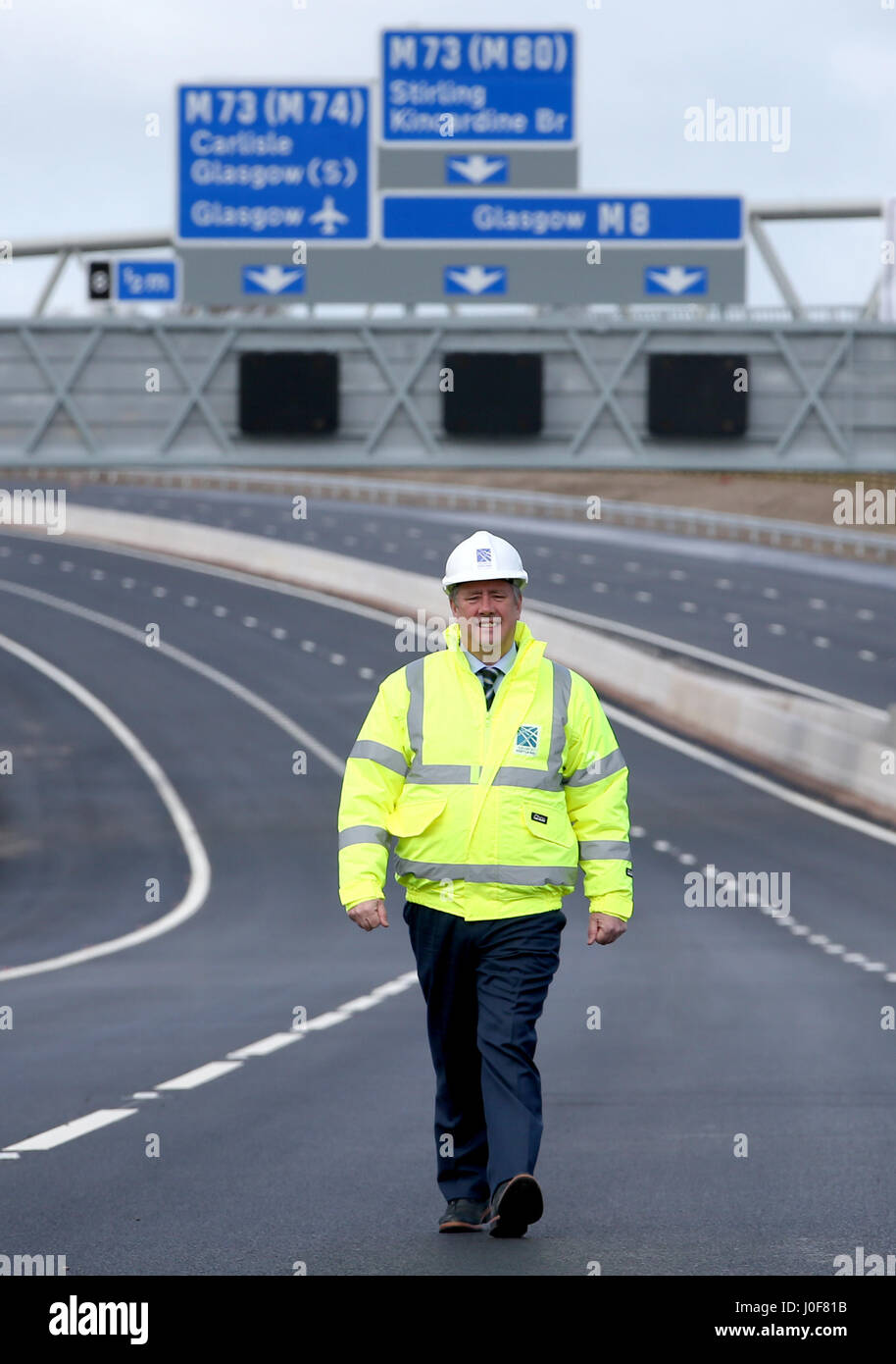 Wirtschaft und Infrastruktur Sekretär Keith Brown auf den neuen Abschnitt auf der M8 Autobahn in der Nähe von Ballieston, North Lanarkshire, das für den Verkehr fast eine Woche vor der Zeitplan eröffnet. Stockfoto