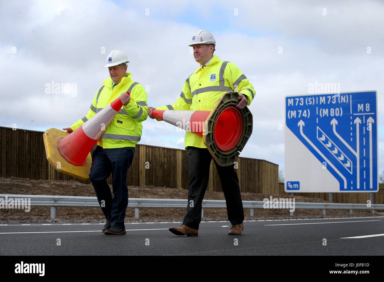 Minister für Wirtschaft und Infrastruktur Keith Brown (links) und Transport Scotland Project Manager Graeme Reid über den neuen Abschnitt auf der Autobahn M8 in der Nähe von Ballieston, North Lanarkshire, der fast eine Woche vor dem Zeitplan für den Verkehr geöffnet werden soll. Stockfoto