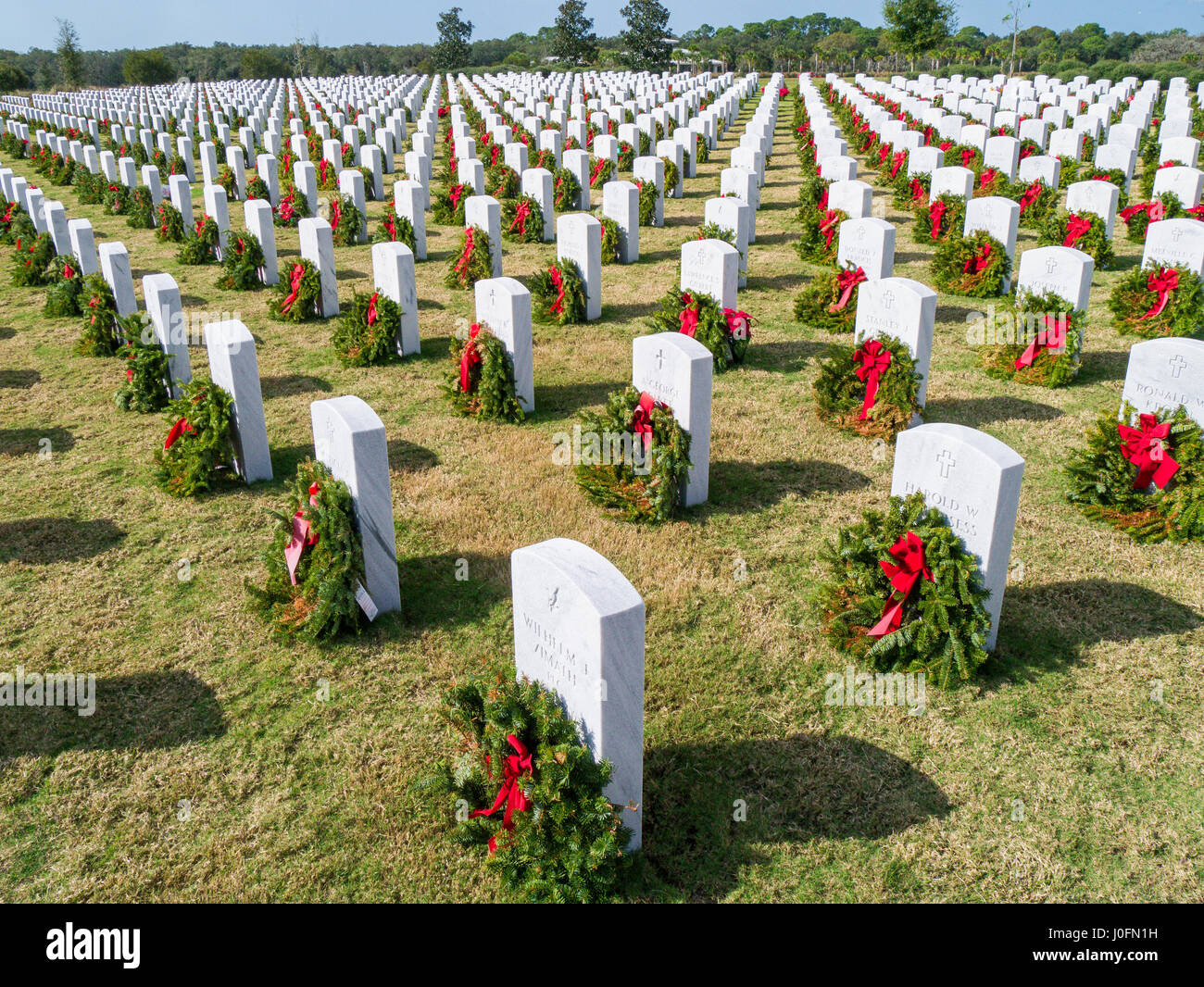 Reihen von Grabsteinen mit Kränze & rote Schleifen in Sarasota National Cemetery in Sarasota Florida Stockfoto