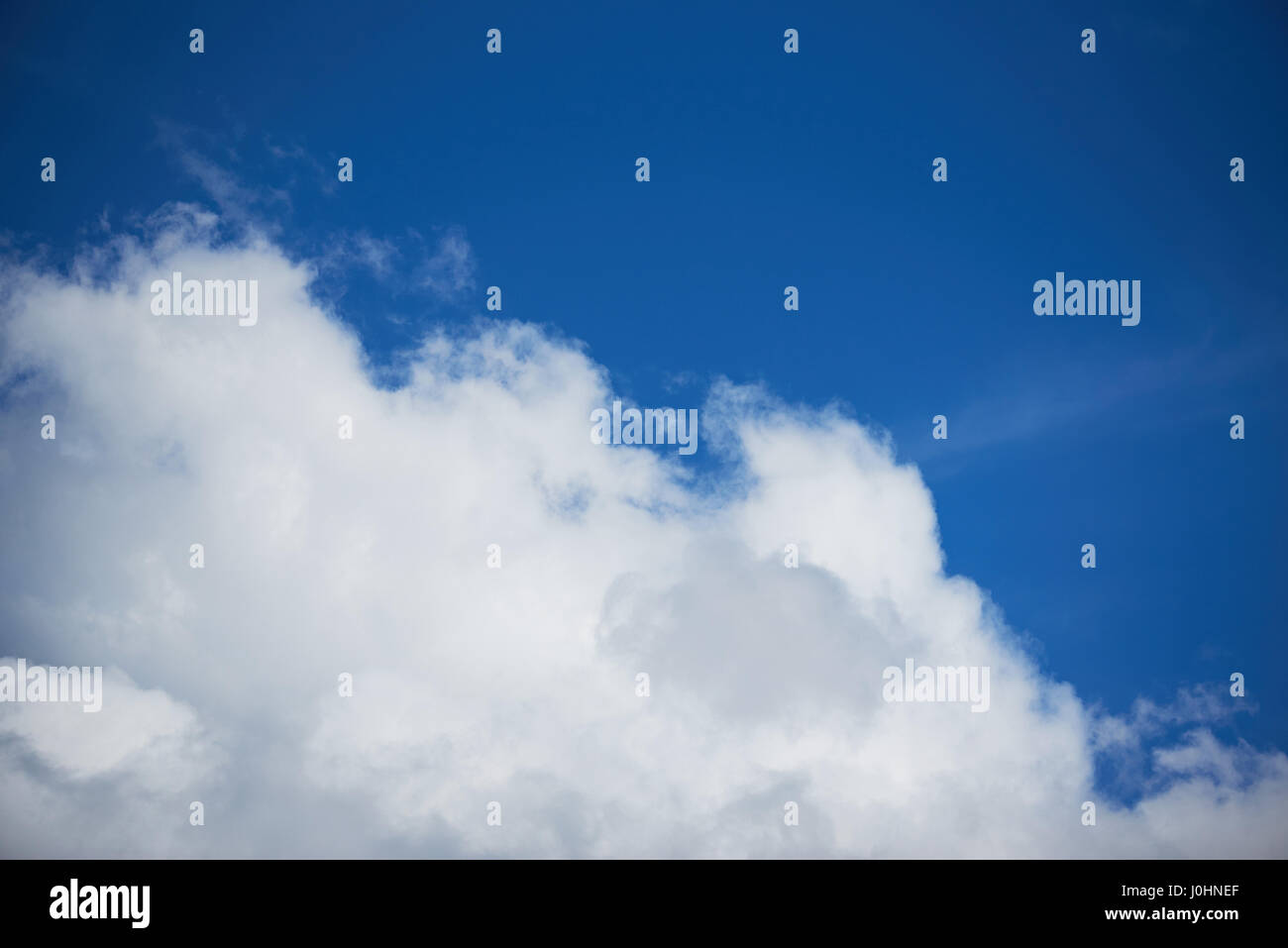 Flauschige große weiße Wolke am Taghimmel Zeit tiefblaue Farbe Stockfoto
