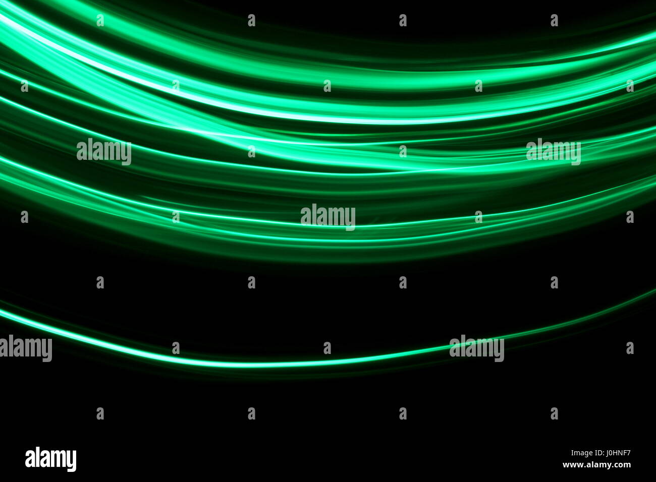 Grünes Licht Malerei Fotografie, Wellen auf schwarzem Hintergrund Stockfoto