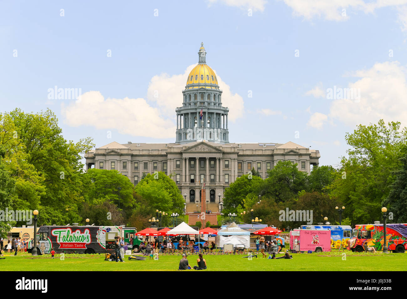 Denver, USA - 25. Mai 2016: The Colorado State Capitol von Civic Center Park mit Imbisswagen vor und Leute sitzen auf dem Rasen gesehen. Stockfoto