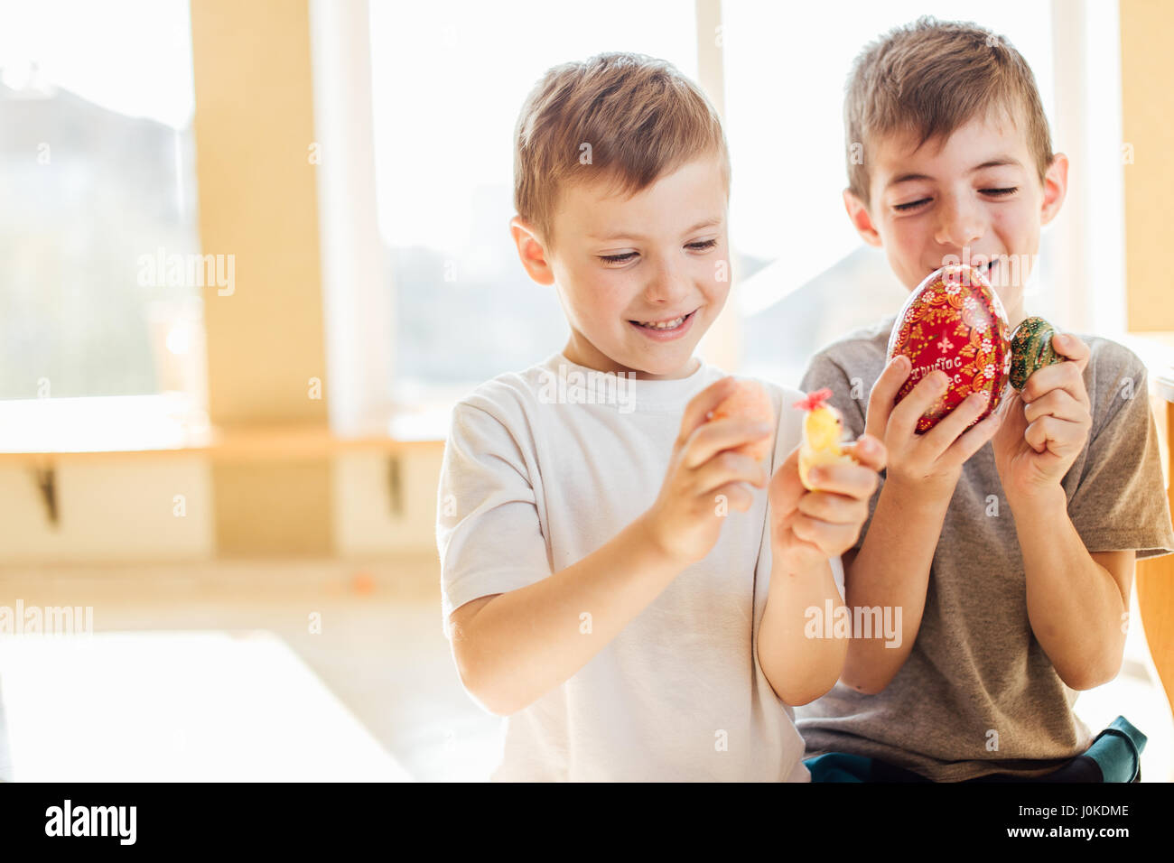 Zwei jungen mit Ostereiern und Lächeln einander Stockfoto