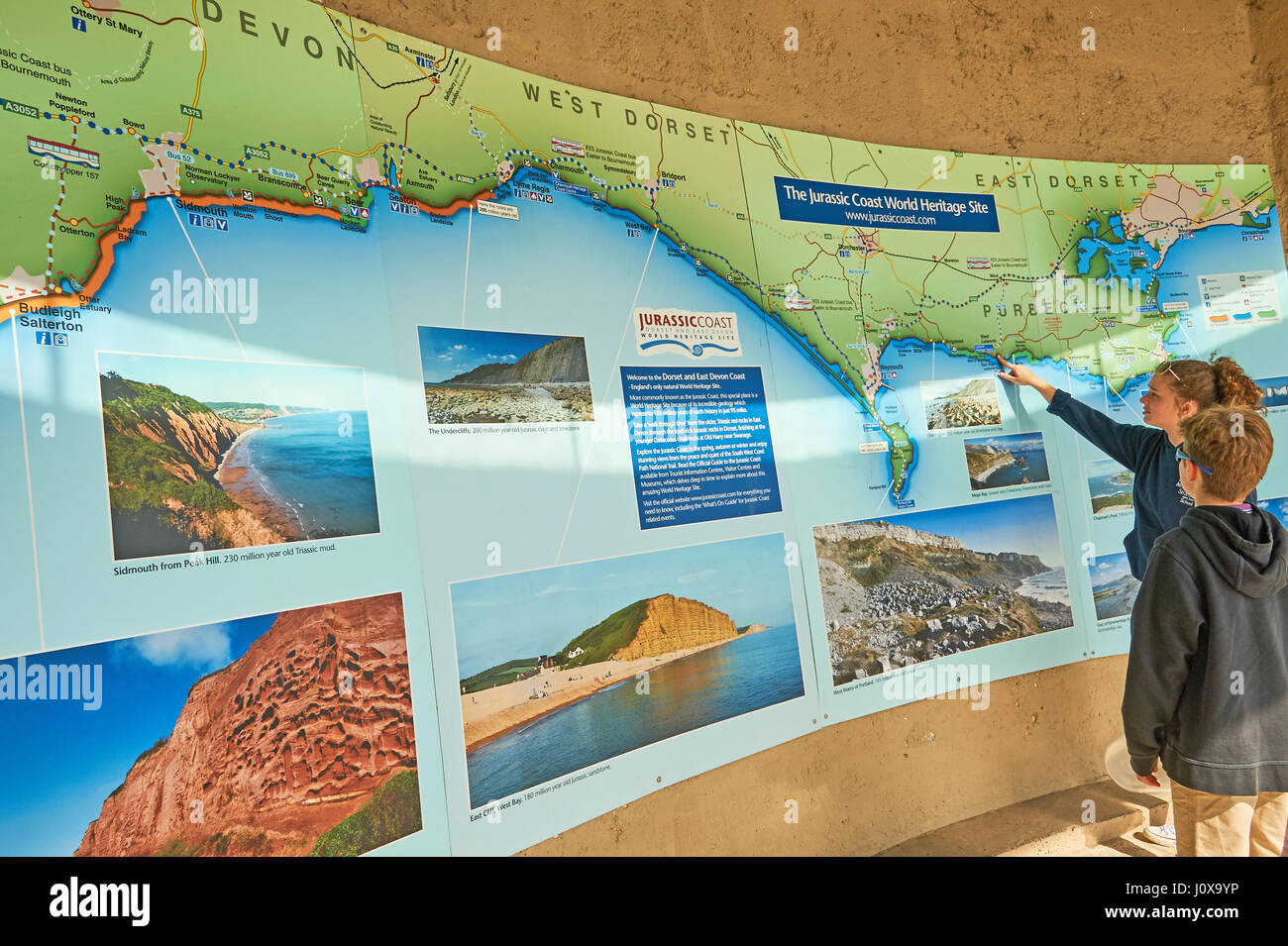 Zwei Kinder suchen sich eine Karte von Dorset Jurassic Coast Stockfoto