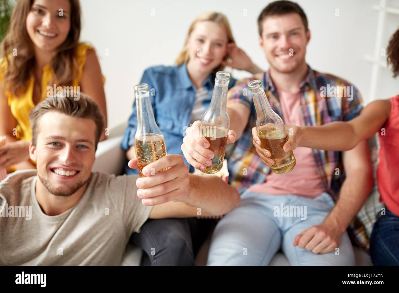 Glückliche Freunde trinken Bier zu Hause feiern Stockfoto