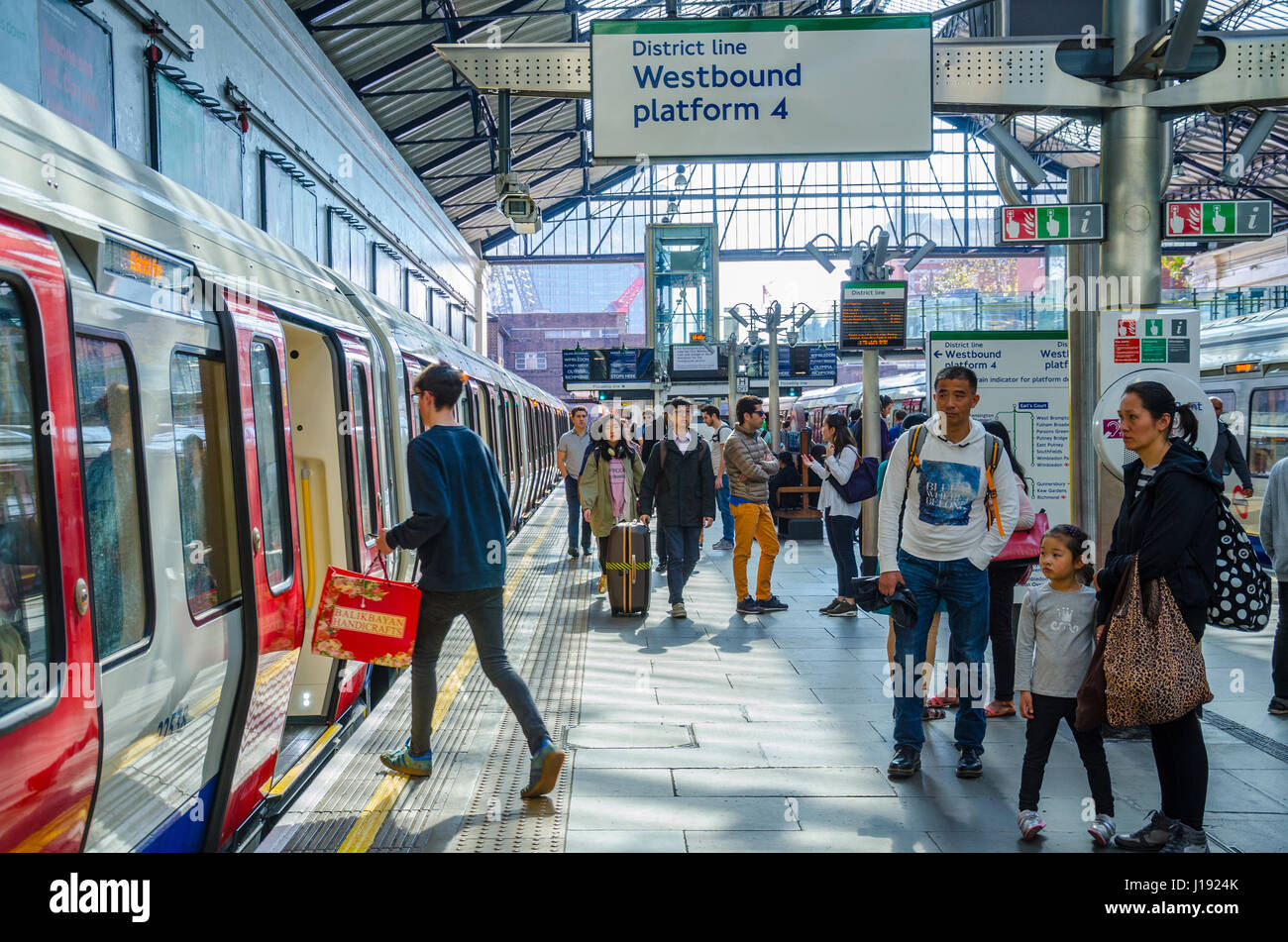 Ein Mann besteigt einen District Line-Zug bei u-Bahnstation Earls Court. Stockfoto