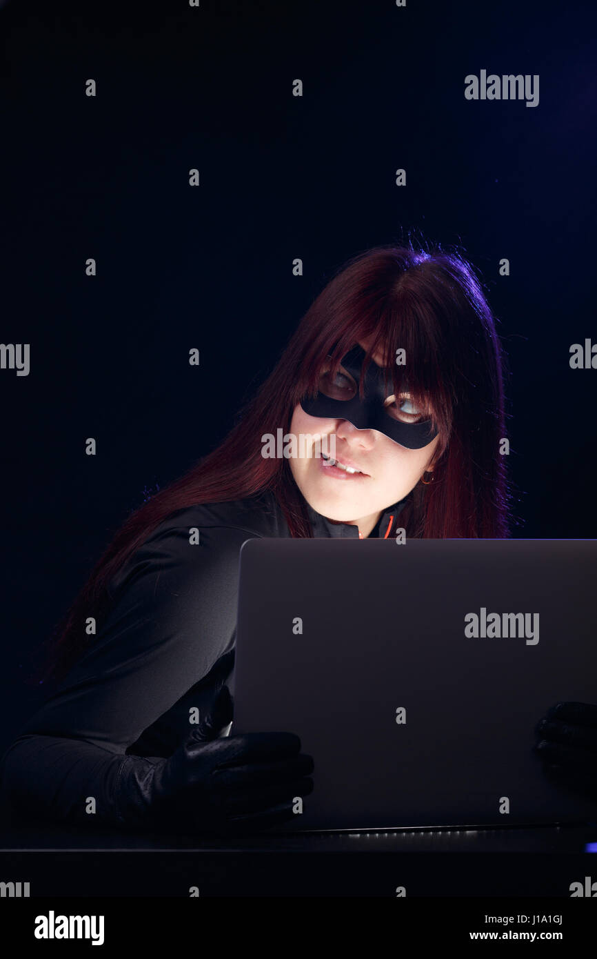 Frau mit Laptop in Maske Stockfoto