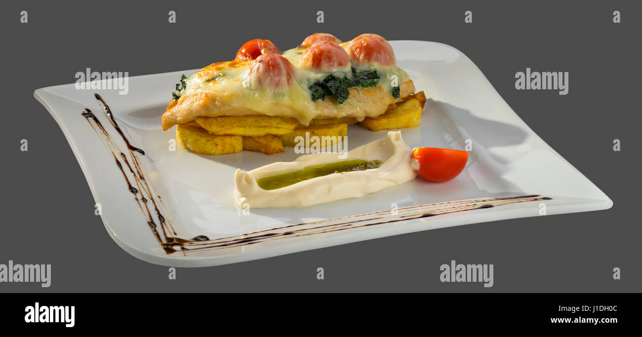 Hähnchenfilet mit gebratenen Karte und gegrillter Käse serviert auf einer Platte auf einem grauen Hintergrund isoliert Stockfoto